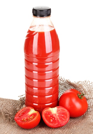 Tomato juice in bottle on sackcloth isolated on whiteの写真素材