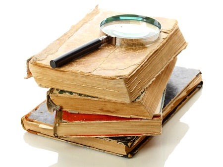 Magnifying glass and books isolated on whiteの写真素材