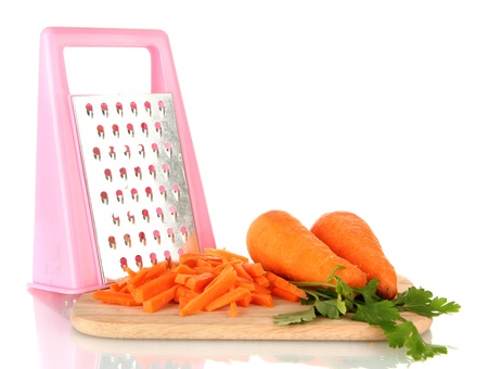 carrots with grater on cutting board isolated on whiteの写真素材