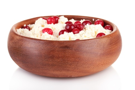 Cottage cheese in color bowl with red berries, isolated on whiteの写真素材