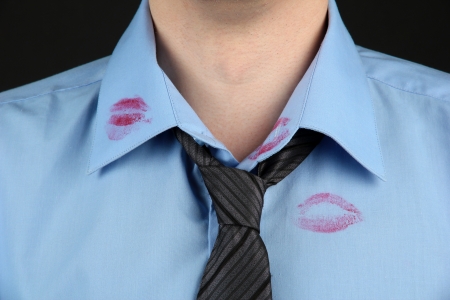 Lipstick kiss on shirt collar of man, isolated on blackの写真素材