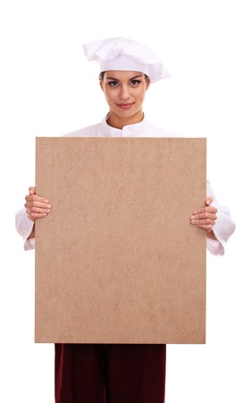 portrait of young woman chef with empty board isolated on whiteの写真素材