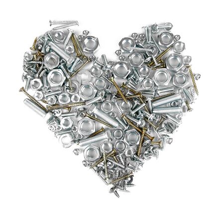 Assorted nuts, screws and bolts heart isolated on whiteの写真素材