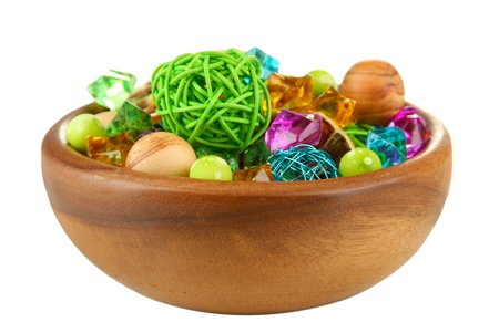 Dried oranges, wicker balls and other home decorations in wooden bowl, isolated on whiteの写真素材