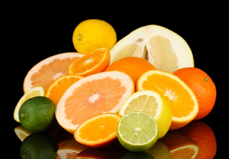 Lots ripe citrus isolated on blackの写真素材
