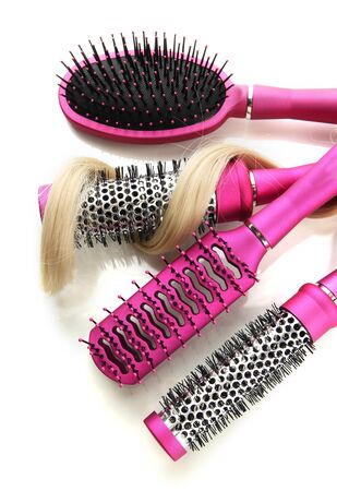 Comb brushes with hair, isolated on whiteの写真素材