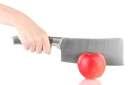 Hand with knife cutting red apple, isolated on whiteの写真素材