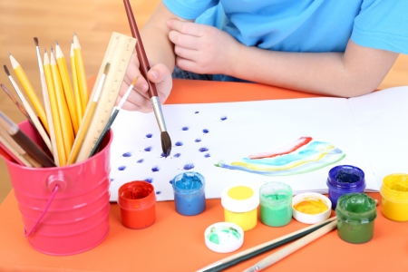 Child painting in his albumの写真素材