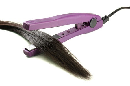 Hair straighteners and hair, isolated on whiteの写真素材