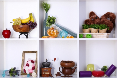 Beautiful white shelves with scattered different home related objectsの写真素材