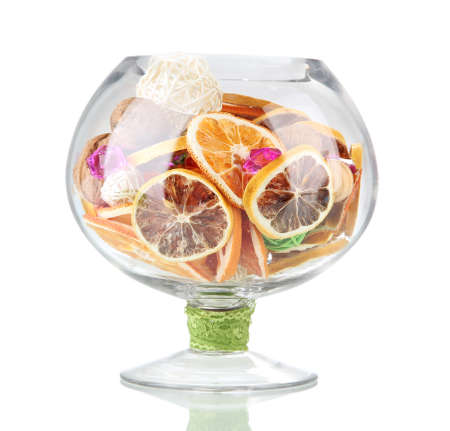 Dried oranges, wicker balls and other home decorations in glass bowl, isolated on whiteの写真素材