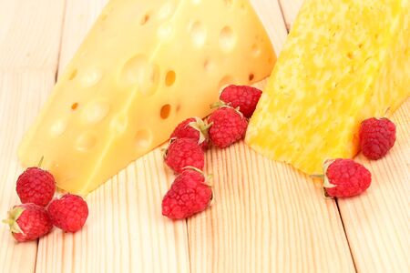 tasty cheese and berries on wooden backgroundの写真素材