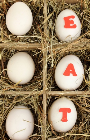 Decorative Easter eggs in wooden basket close upの写真素材