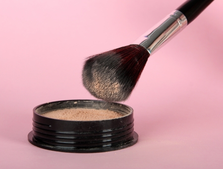 Powder and brush on pink background