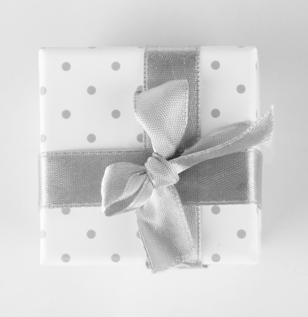 Color gift box with silver ribbon, isolated on whiteの写真素材