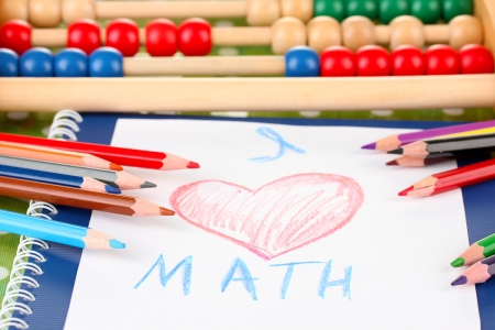 Toy abacus, notebook, pencils on bright backgroundの写真素材