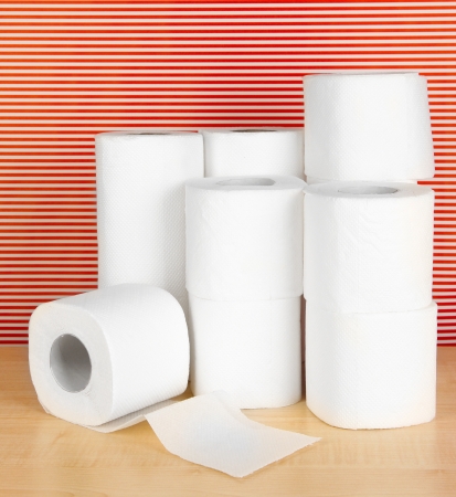 Rolls of toilet paper on striped red backgroundの写真素材