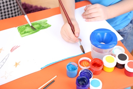 Child painting in his albumの写真素材