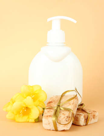 Liquid and hand-made soaps on beige backgroundの写真素材