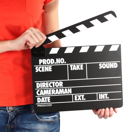 Movie production clapper board in hands isolated on whiteの写真素材