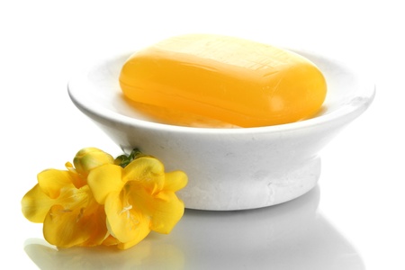 Soap-dish with soap and flower isolated on whiteの写真素材