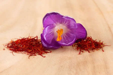 Beautiful purple crocus and saffron, on wooden backgroundの写真素材
