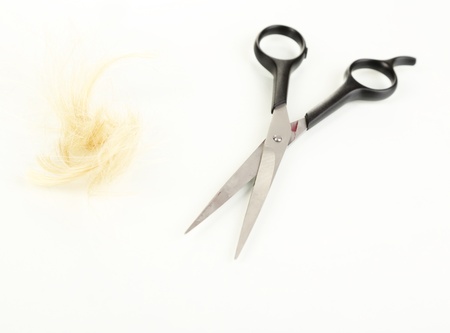 Pieces of hair cut with scissors isolated on white