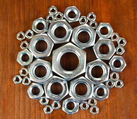 Screw nuts on wooden table
