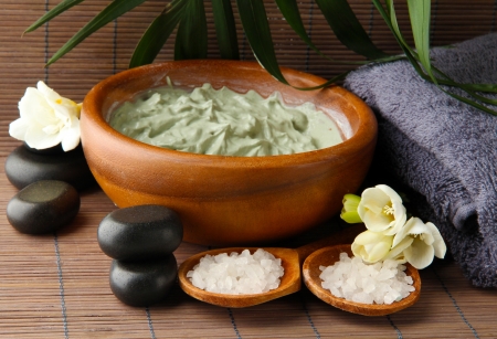 Composition with cosmetic clay for spa treatments, on bamboo backgroundの写真素材