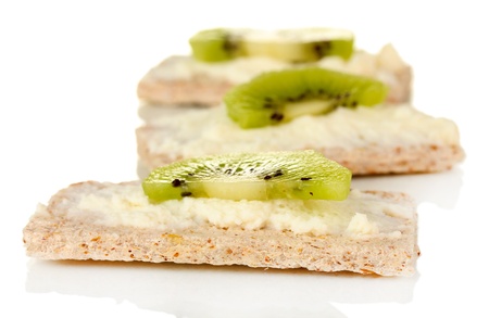 Crispbread with cheese and kiwi, isolated on whiteの写真素材