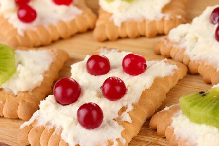 Cookie with cheese and cranberry, kiwi, on wooden backgroundの写真素材