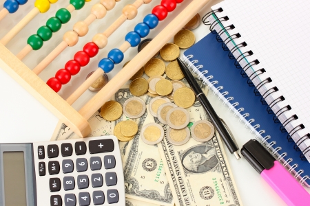 Bright wooden abacus and calculator. Conceptual photo of old and modern businessの写真素材