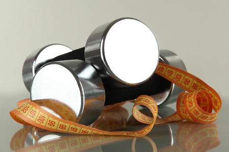 Dumbbells with centimeter on grey backgroundの写真素材