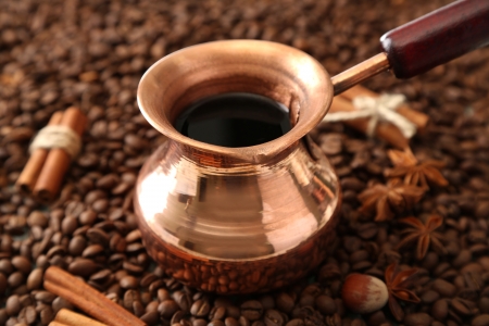 Pot of coffee on coffee beans backgroundの写真素材