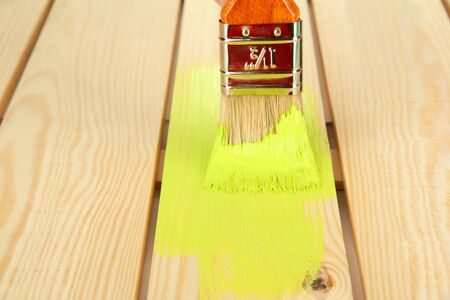 Brush painting wooden furniture, close upの写真素材