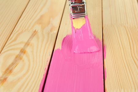 Brush painting wooden furniture, close upの写真素材