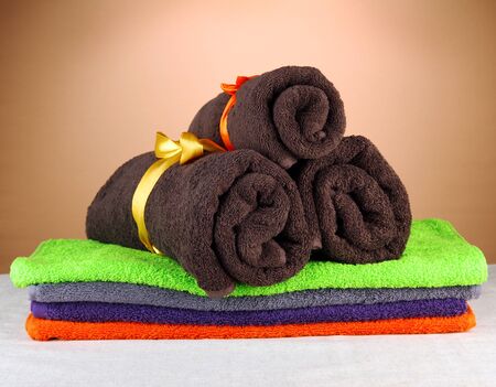 Colorful towels, on brown backgroundの写真素材