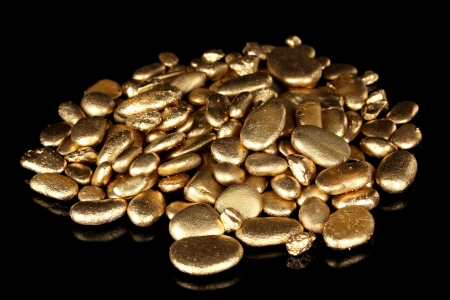 Golden stones isolated on blackの写真素材