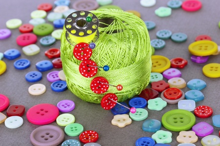Buttons of different shapes, sizes and colors close-up on gray background