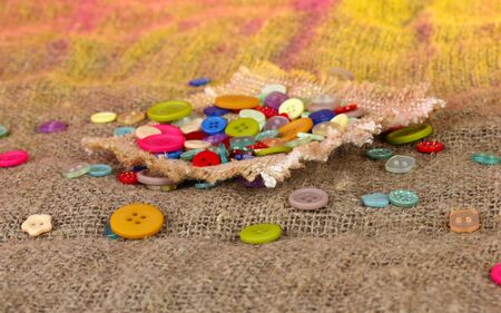 Beautiful buttons and a ball of yarn on a bright backgroundの写真素材