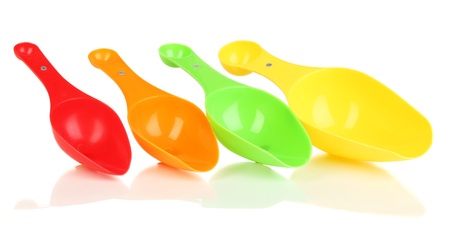 Empty measuring cups for washing powder isolated on whiteの写真素材