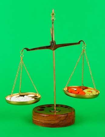 Classic scales with color pills on color backgroundの写真素材