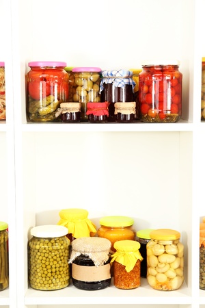 Different conservations on white shelvesの写真素材