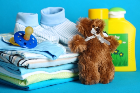Pile of baby clothes on blue backgroundの写真素材