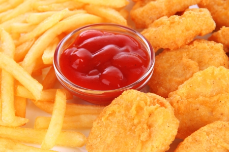 Fried chicken nuggets with french fries and sauce isolated on whiteの写真素材