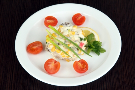 Small portion of food on big plate on wooden tableの写真素材