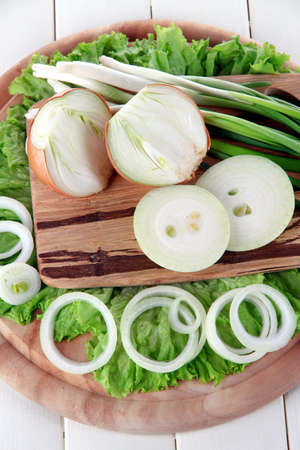Composition with herbs and onions on wooden tableの写真素材