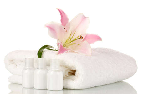 beautiful lily with towel and bottles isolated on whiteの写真素材