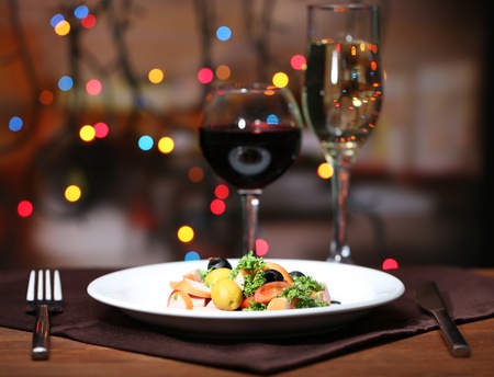 Tasty salad on dark background with bokeh  defocused lightsの写真素材
