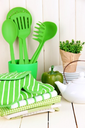 Kitchen settings: utensil, potholders, towels and else  on wooden tableの写真素材
